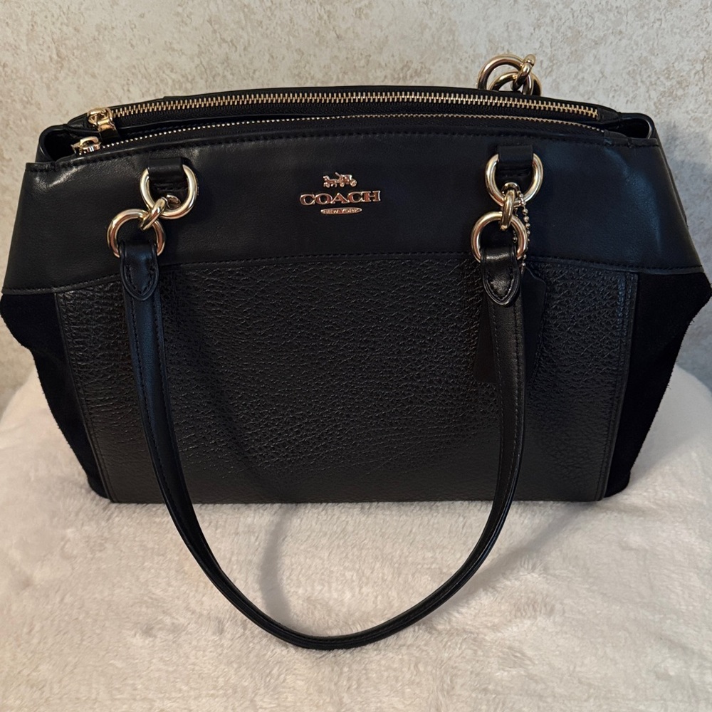 Coach Black and Gold Shoulder Bag with crossbody strap. Suede ends.
